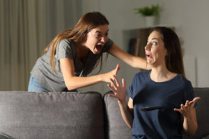 Daughter snuck up behind her mom and scared her on the couch