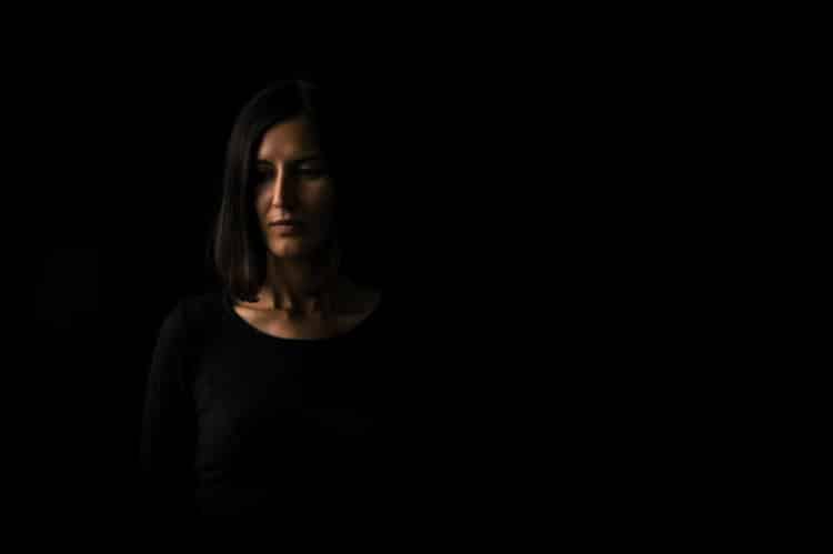 Introspective woman in darkened room