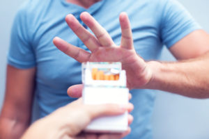 person resisting offer of cigarettes